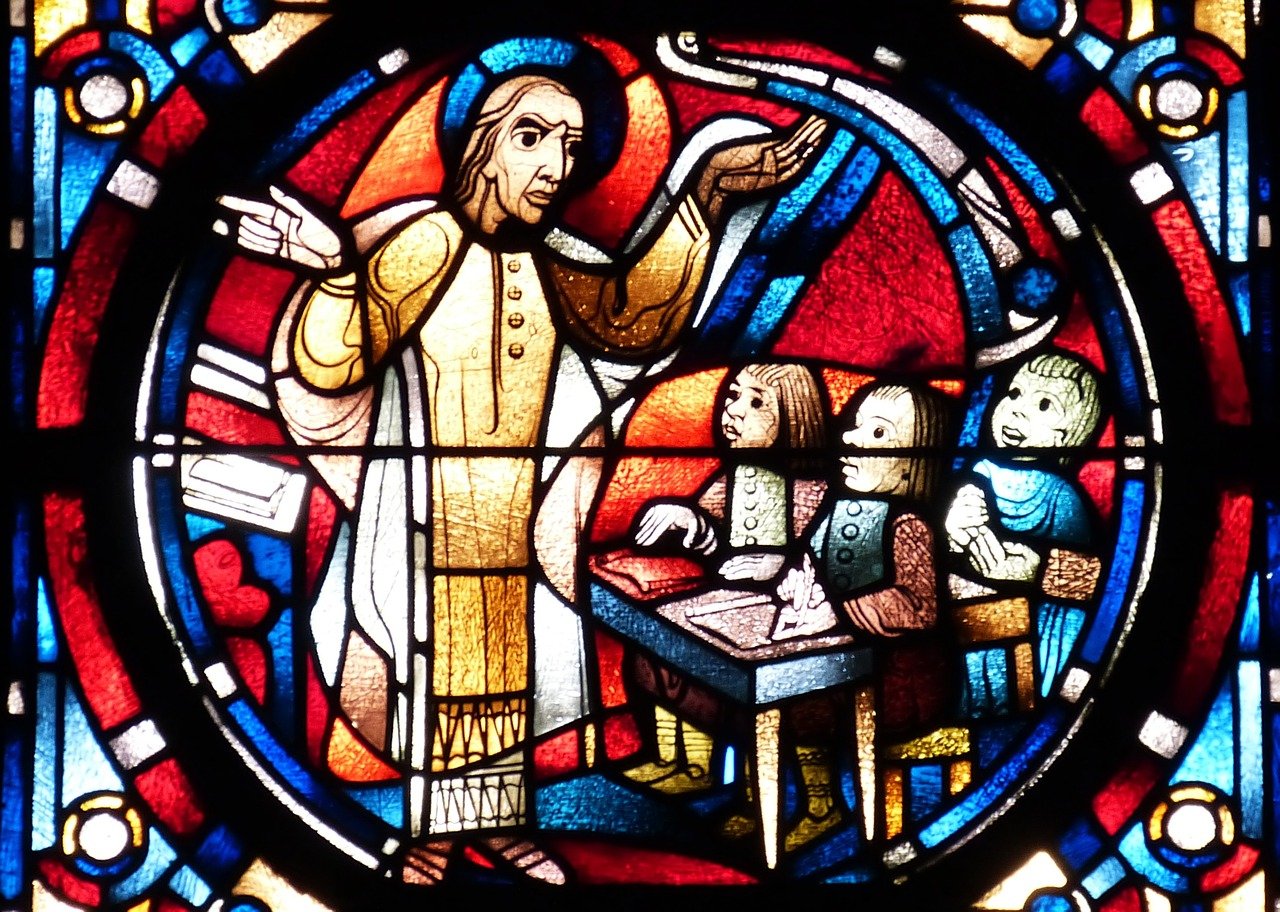 A cleric teaching catechism classes to children